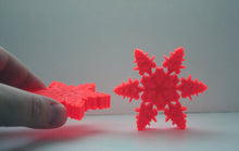 Load image into Gallery viewer, Orange snowflakes laser cut and engraved from thick acrylic in two limited edition designs