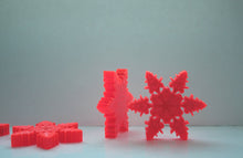 Load image into Gallery viewer, Orange snowflakes laser cut and engraved from thick acrylic in two limited edition designs