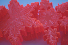 Load image into Gallery viewer, Orange snowflakes laser cut and engraved from thick acrylic in two limited edition designs