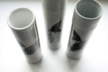 Load image into Gallery viewer, Bud vase made from gray earthenware with glossy effect and a butterfly on a feather