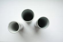 Load image into Gallery viewer, Bud vase made from gray earthenware with glossy effect and a butterfly on a feather