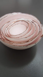 Set of 7 stoneware fine bone china nesting bowls in dusty pink and white with various finishes.