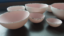 Load image into Gallery viewer, Set of 7 stoneware fine bone china nesting bowls in dusty pink and white with various finishes.