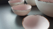 Load image into Gallery viewer, Set of 7 stoneware fine bone china nesting bowls in dusty pink and white with various finishes.