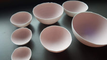 Load image into Gallery viewer, Set of 7 stoneware fine bone china nesting bowls in dusty pink and white with various finishes.