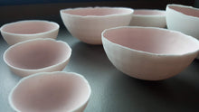 Load image into Gallery viewer, Set of 7 stoneware fine bone china nesting bowls in dusty pink and white with various finishes.