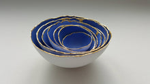 Load image into Gallery viewer, Set of 7 stoneware fine bone china nesting bowls in blue and white with real gold finish.