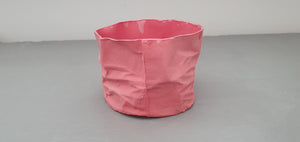 Crumpled paper looking white vessel made out of English fine bone china in pale red / dark pink colour and glazed rims. one off piece