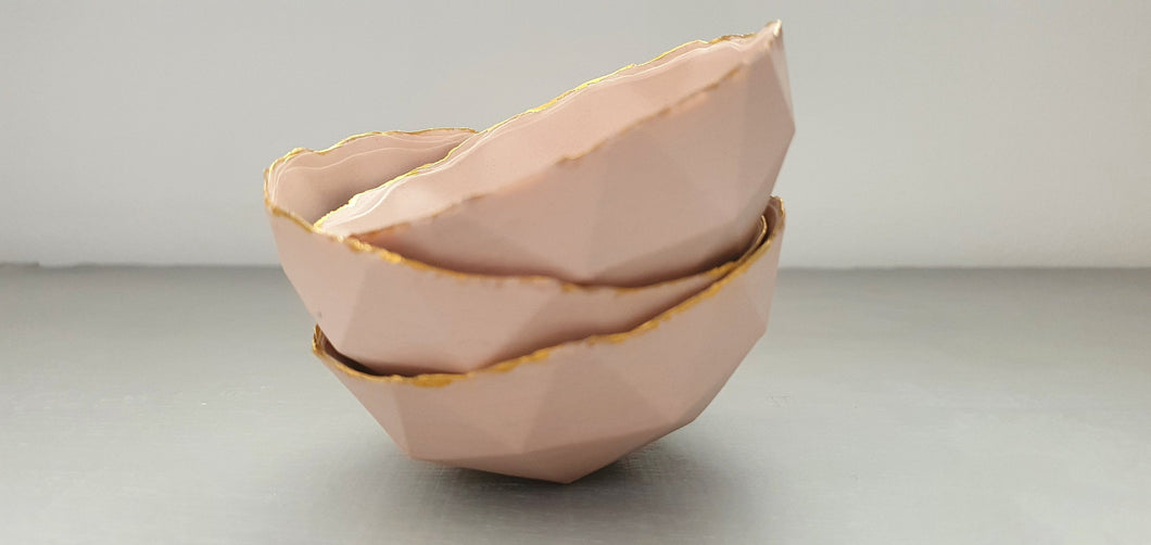 Geometric faceted polyhedron in tan pink bowl made from fine bone china with real mat gold finish - ring dish