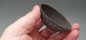 Stoneware small decorative bowl with chocolate black clay and hand drawn exterior pattern.