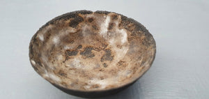 Stoneware small decorative bowl with chocolate black clay and textured interior.