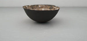 Stoneware small decorative bowl with chocolate black clay and textured interior.