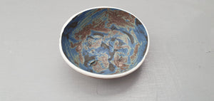 Stoneware small decorative bowl with chocolate, black and blue glaze and textured base.
