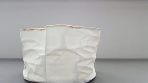 White with gold vessel. Crumpled paper-looking vessel made out of fine bone china with real gold and a hint of turquoise