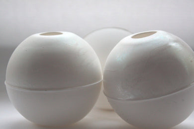 Bud vase. White spheres made from fine bone china with a hint of mother of pearl on the top half