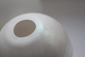 Bud vase. White spheres made from fine bone china with a hint of mother of pearl on the top half