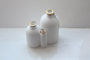 Trio of English fine bone china bottles with gold rims