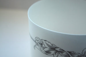 White candle holder. Fine white bone china stoneware vessel or tealight holder with a black motif.