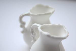 Mini jug made from pure white fine bone china and mother of pearl rim and handle in stoneware