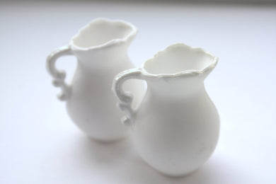 Mini jug made from pure white fine bone china and mother of pearl rim and handle in stoneware