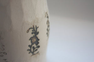 Earthenware vessel handthrown with an aged look and embossed birds on branches