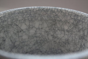 Earthenware vessel handthrown with an aged look and embossed branches and bird cage