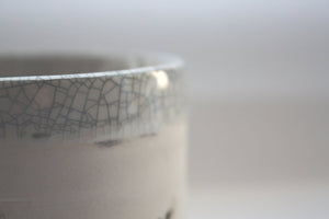 Earthenware vessel handthrown with an aged look and embossed branches and bird cage