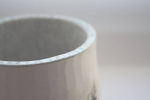 Earthenware vessel handthrown with an aged look and embossed birds on branches
