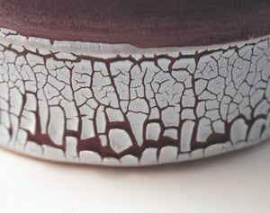 Handthrown earthenware vessel with unique texture and powder effect in red color