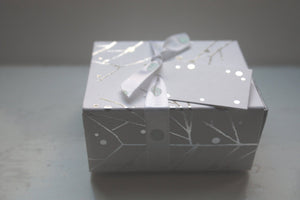 White gift box matchbox style with silver branches and ribbon,