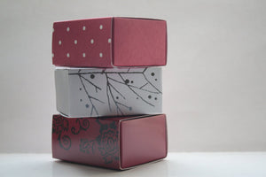 Red gift box matchbox style with black floral pattern and ribbon