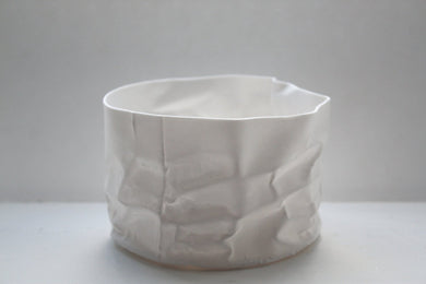 Crumpled paper looking white vessel made out of English fine bone china