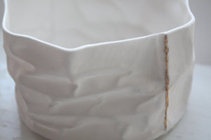 Small vessel. Crumpled paper looking vessel made out of fine bone china with real gold lines