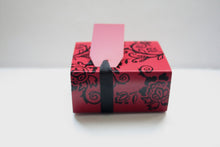 Load image into Gallery viewer, Red gift box matchbox style with black floral pattern and ribbon