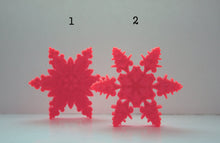 Load image into Gallery viewer, Orange snowflakes laser cut and engraved from thick acrylic in two limited edition designs