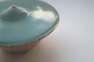 Small ceramic vessel in turquoise and toasted effect in unusual shape