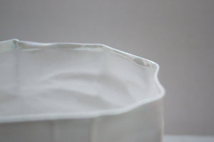 Crumpled paper looking vessel made out of English fine bone china and mother of pearl.