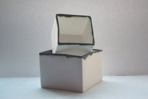 Pure white cube set made from fine bone china and burnt effect rims - geometric decor