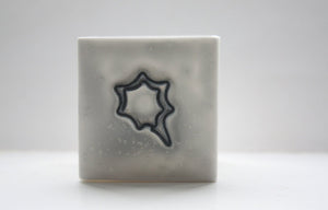 Small snow white cube made from fine bone china and embossed star shape pattern - geometric decor