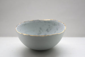 Stoneware porcelain bowl in duck egg blue with mat gold rims mat interior and crystals.