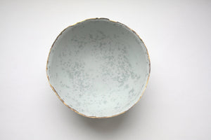 Stoneware porcelain bowl in duck egg blue with mat gold rims mat interior and crystals.